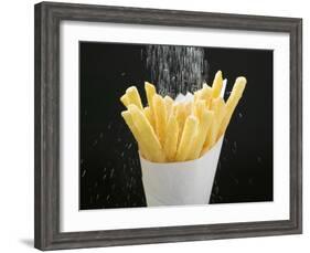 Sprinkling Salt over Chips-null-Framed Photographic Print