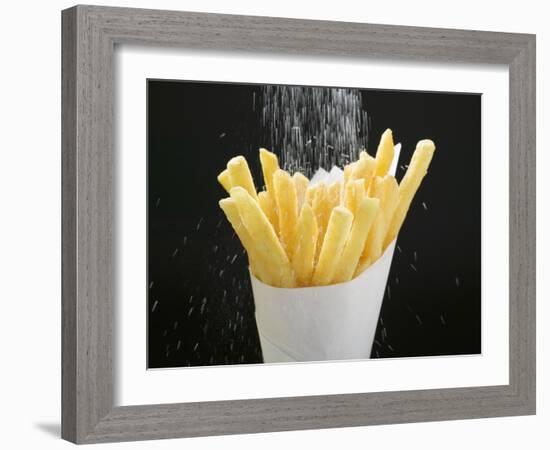 Sprinkling Salt over Chips-null-Framed Photographic Print