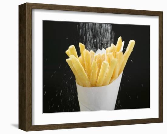 Sprinkling Salt over Chips-null-Framed Photographic Print