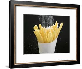 Sprinkling Salt over Chips-null-Framed Photographic Print