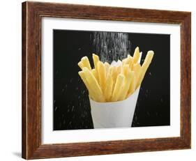 Sprinkling Salt over Chips-null-Framed Photographic Print
