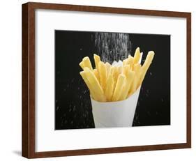 Sprinkling Salt over Chips-null-Framed Photographic Print