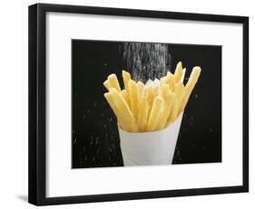 Sprinkling Salt over Chips-null-Framed Photographic Print