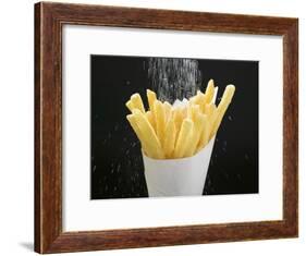 Sprinkling Salt over Chips-null-Framed Photographic Print