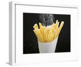 Sprinkling Salt over Chips-null-Framed Photographic Print
