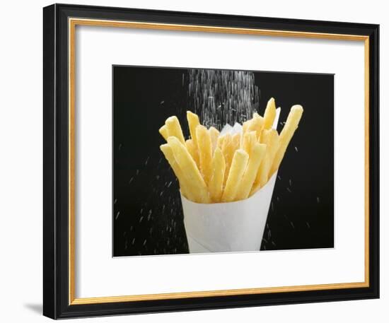 Sprinkling Salt over Chips-null-Framed Photographic Print