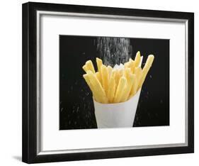 Sprinkling Salt over Chips-null-Framed Photographic Print