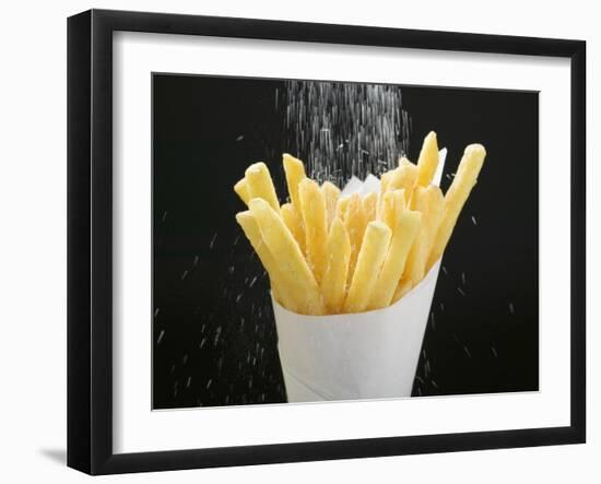 Sprinkling Salt over Chips-null-Framed Photographic Print