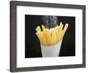 Sprinkling Salt over Chips-null-Framed Photographic Print