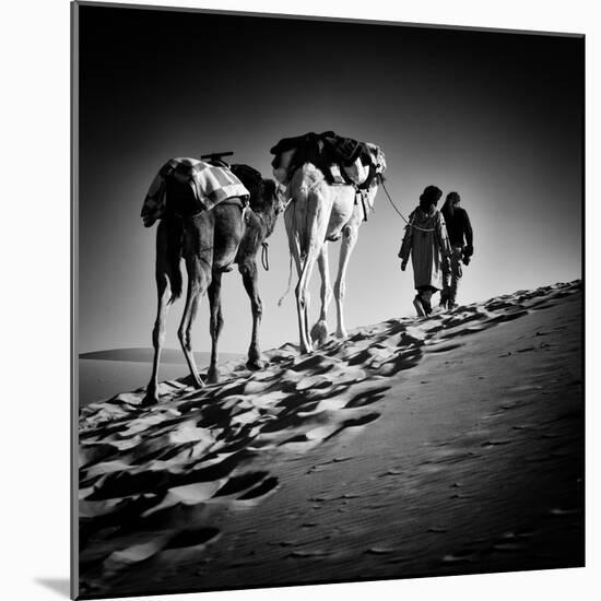 Square Black & White Image of 2 Men and 2 Camels in Sahara Desert-ABO PHOTOGRAPHY-Mounted Photographic Print