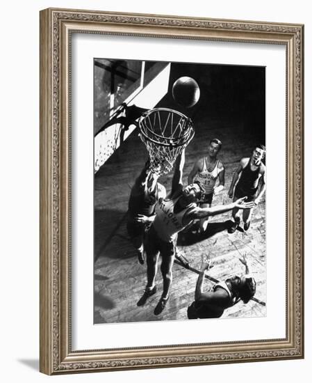 St. John's University Player Ivor Sumner Making a Lay-up Basket Through a "Keaney Ring"-Gjon Mili-Framed Photographic Print