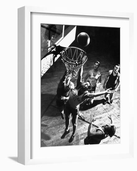 St. John's University Player Ivor Sumner Making a Lay-up Basket Through a "Keaney Ring"-Gjon Mili-Framed Photographic Print