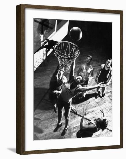 St. John's University Player Ivor Sumner Making a Lay-up Basket Through a "Keaney Ring"-Gjon Mili-Framed Photographic Print