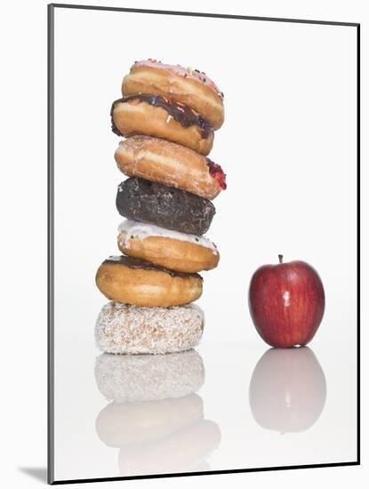 Stack of Donuts and One Apple-null-Mounted Photographic Print