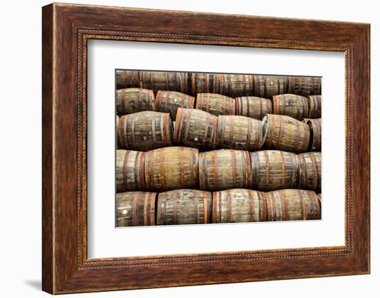 Stacked Pile of Old Whisky and Wine Wooden Barrels-MartinM303-Framed Photographic Print