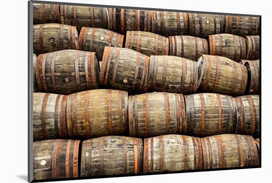 Stacked Pile of Old Whisky and Wine Wooden Barrels-MartinM303-Mounted Photographic Print