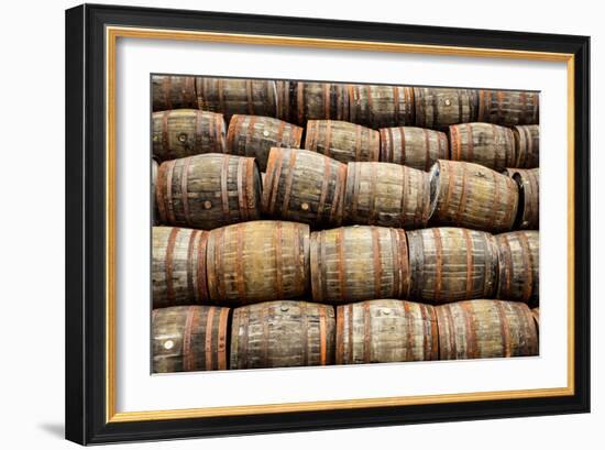 Stacked Pile of Old Whisky and Wine Wooden Barrels-MartinM303-Framed Photographic Print