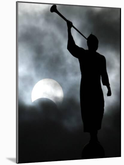 Statue is Seen Against a Cloudy Sky and a Partial Solar Eclipse in Bogota, Colombia-null-Mounted Photographic Print