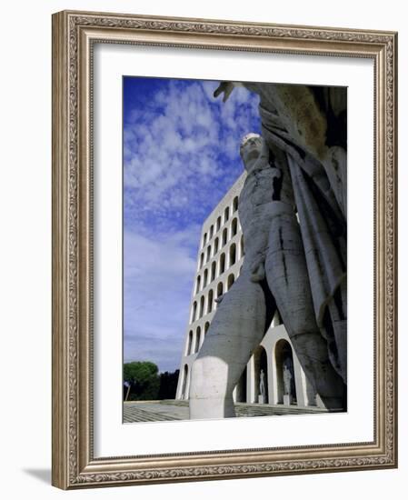 Statue with the Palazzo Della Civilta Di Lavoro Behind, Eur, Lazio, Italy-Oliviero Olivieri-Framed Photographic Print