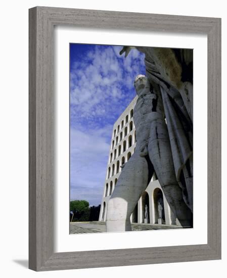 Statue with the Palazzo Della Civilta Di Lavoro Behind, Eur, Lazio, Italy-Oliviero Olivieri-Framed Photographic Print