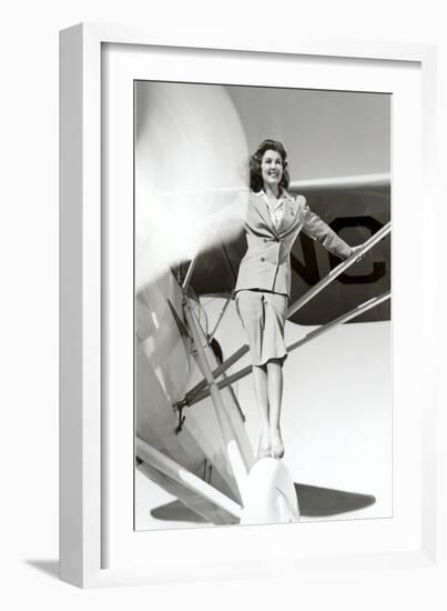 Stewardess Balancing on Plane Wheel--Framed Art Print