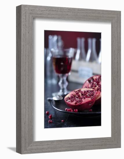 Still Life with Sliced Pomegranate, Glass with Pomegranate Juice and Bottles-Jana Ihle-Framed Photographic Print