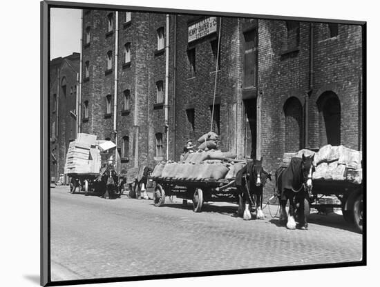 Stock Is Unloaded from Horse- Pulled Wagons and Drawn Up into the Warehouse by Rope-null-Mounted Photographic Print