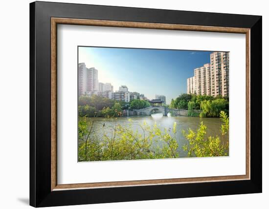 Stone bridge with pagoda style roofing, flanked by old style apartment buildings on the left and ne-Andreas Brandl-Framed Photographic Print