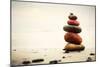 Stones Pyramid on Sand Symbolizing Zen, Harmony, Balance. Ocean in the Background-Michal Bednarek-Mounted Photographic Print