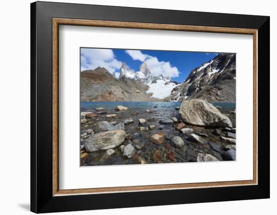 Stones seen through the water of Lago de los Tres featuring Monte Fitz Roy in the background. Monte-Fernando Carniel Machado-Framed Photographic Print