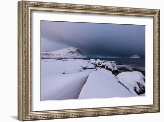 Storm clouds on the snowy peaks reflected in the cold sea at night, Haukland, Northern Norway-Roberto Moiola-Framed Photographic Print