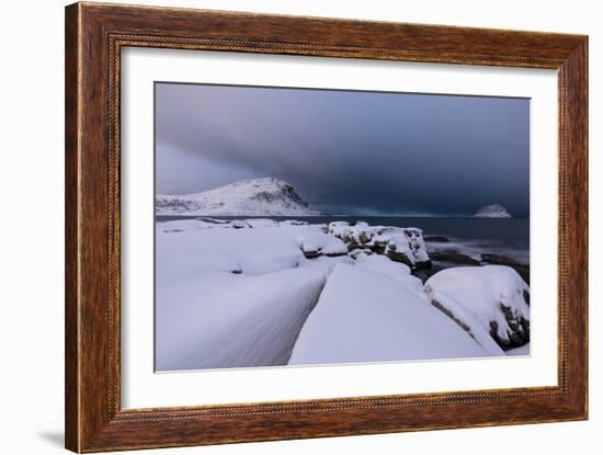 Storm clouds on the snowy peaks reflected in the cold sea at night, Haukland, Northern Norway-Roberto Moiola-Framed Photographic Print