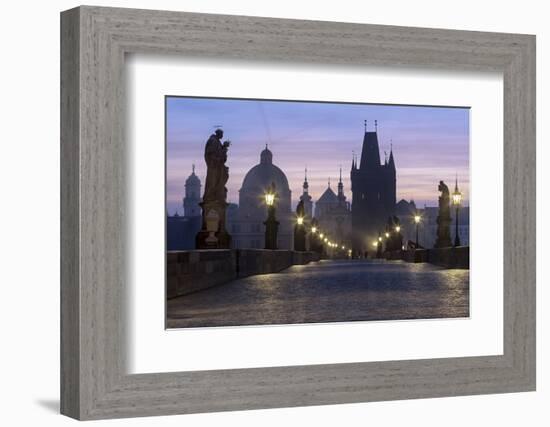 Street lanterns and old statues frame the historical buildings on Charles Bridge at dawn, UNESCO Wo-Roberto Moiola-Framed Photographic Print