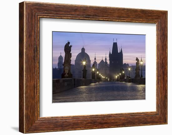 Street lanterns and old statues frame the historical buildings on Charles Bridge at dawn, UNESCO Wo-Roberto Moiola-Framed Photographic Print