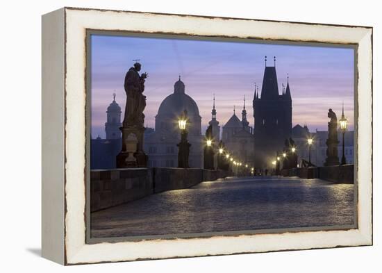 Street lanterns and old statues frame the historical buildings on Charles Bridge at dawn, UNESCO Wo-Roberto Moiola-Framed Premier Image Canvas