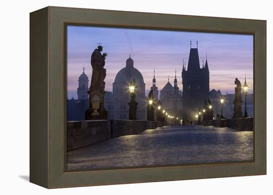 Street lanterns and old statues frame the historical buildings on Charles Bridge at dawn, UNESCO Wo-Roberto Moiola-Framed Premier Image Canvas