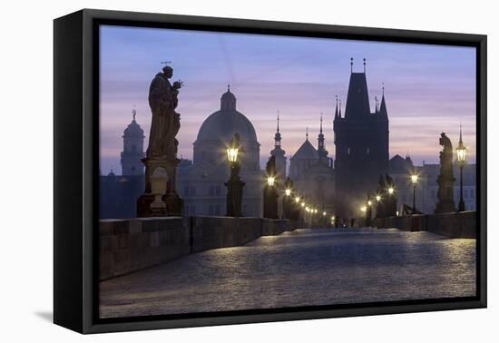 Street lanterns and old statues frame the historical buildings on Charles Bridge at dawn, UNESCO Wo-Roberto Moiola-Framed Premier Image Canvas