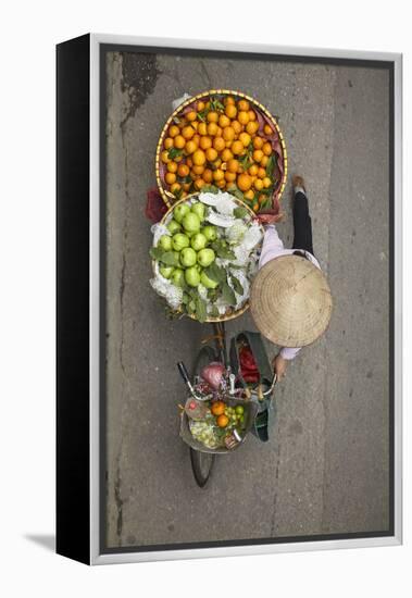 Street vendor with baskets of fruit on bicycle, Old Quarter, Hanoi, Vietnam-David Wall-Framed Premier Image Canvas