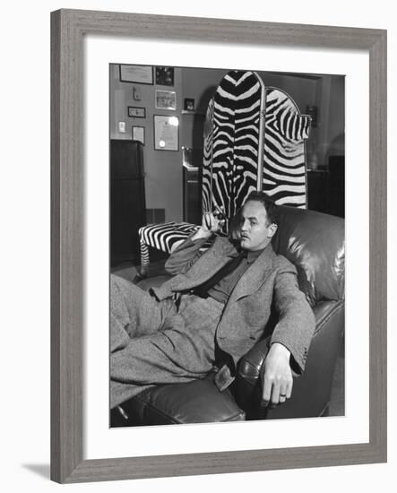 Studio Head Darryl F. Zanuck Relaxing with Cigar in Front of Zebra Skin Screen He Shot in Africa-Margaret Bourke-White-Framed Premium Photographic Print