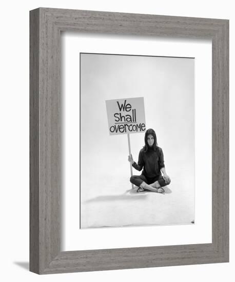 Studio Photos of Gloria Steinem Sitting on Floor with Sign That Says 'We Shall Overcome", 1965-Yale Joel-Framed Photographic Print