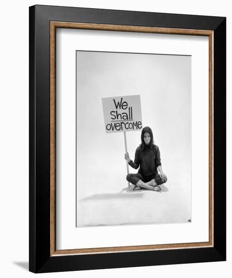 Studio Photos of Gloria Steinem Sitting on Floor with Sign That Says 'We Shall Overcome", 1965-Yale Joel-Framed Photographic Print