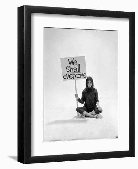 Studio Photos of Gloria Steinem Sitting on Floor with Sign That Says 'We Shall Overcome", 1965-Yale Joel-Framed Photographic Print