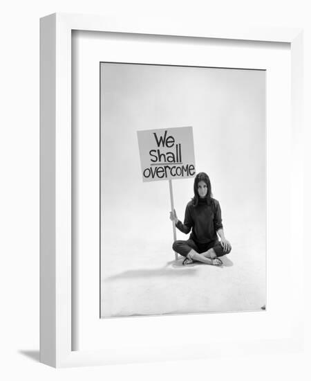 Studio Photos of Gloria Steinem Sitting on Floor with Sign That Says 'We Shall Overcome", 1965-Yale Joel-Framed Photographic Print