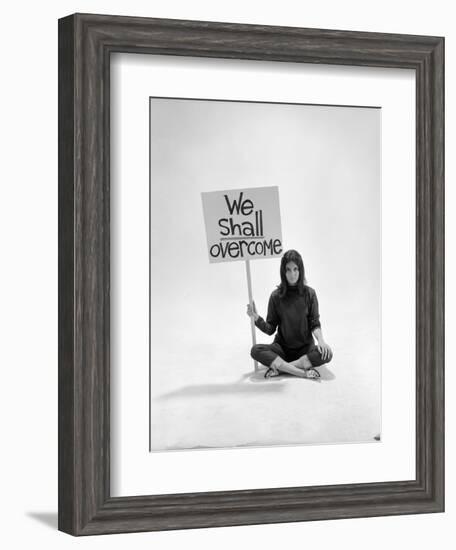 Studio Photos of Gloria Steinem Sitting on Floor with Sign That Says 'We Shall Overcome", 1965-Yale Joel-Framed Premium Photographic Print
