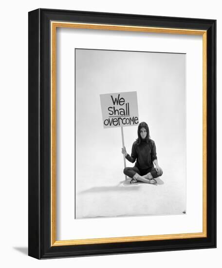 Studio Photos of Gloria Steinem Sitting on Floor with Sign That Says 'We Shall Overcome", 1965-Yale Joel-Framed Premium Photographic Print