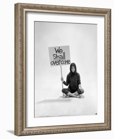 Studio Photos of Gloria Steinem Sitting on Floor with Sign That Says 'We Shall Overcome", 1965-Yale Joel-Framed Photographic Print