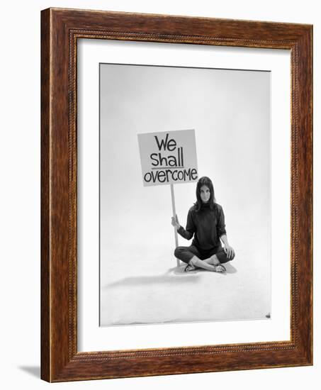 Studio Photos of Gloria Steinem Sitting on Floor with Sign That Says 'We Shall Overcome", 1965-Yale Joel-Framed Photographic Print