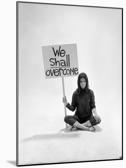 Studio Photos of Gloria Steinem Sitting on Floor with Sign That Says 'We Shall Overcome", 1965-Yale Joel-Mounted Photographic Print