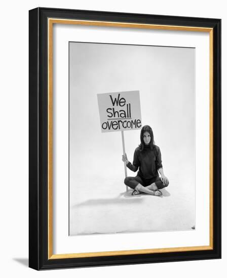 Studio Photos of Gloria Steinem Sitting on Floor with Sign That Says 'We Shall Overcome", 1965-Yale Joel-Framed Photographic Print