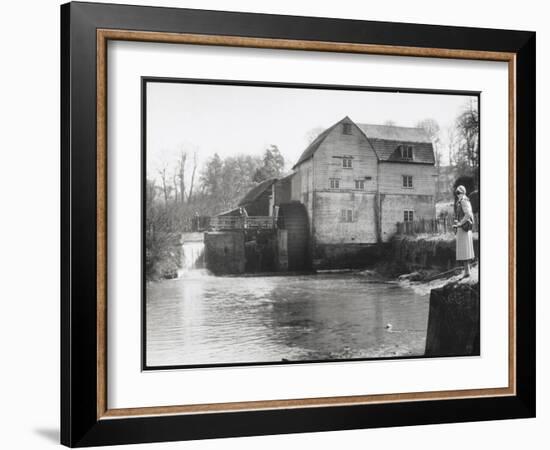 Stylish Woman Well Wrapped up for a Cold Day Stops to Admire Castle Mill Dorking Surrey England-null-Framed Art Print